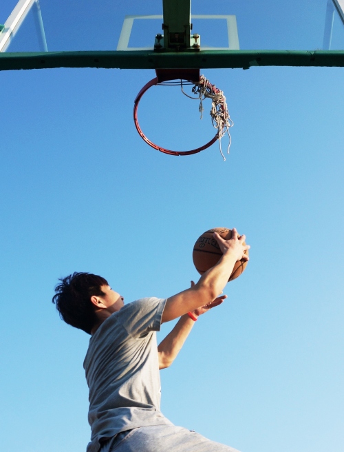 man makes basketball goal