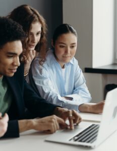 group looks at laptop